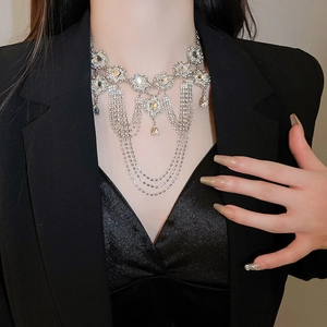 Detail of silver layered fringe necklace with crystal teardrops on a model