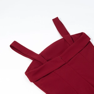 Detail view of the back of a red backless dress featuring a zipper and wide shoulder straps
