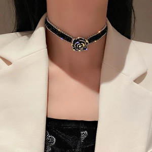 Elegant black rose choker necklace with crystal embellishments on black stone strap