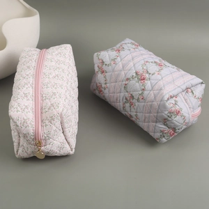 Quilted floral cosmetic bags in pink and blue rose patterns with secure zipper closures