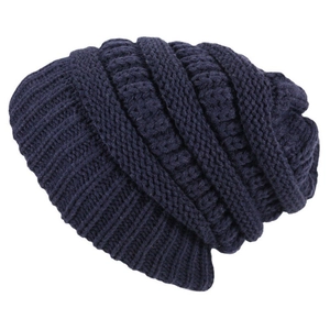 Detail of navy blue cable knit beanie featuring thick texture and satin lining for winter warmth