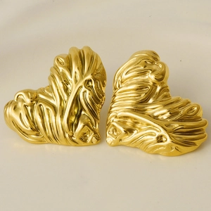 Macro view of gold irregular textured heart earrings made of 304 stainless steel