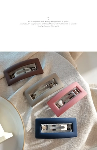 Set of four matte rectangular hair clips in brown, beige, pink and navy on linen fabric