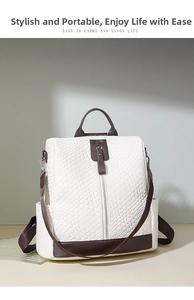 Close-up of white woven PU leather backpack with brown trim and secure vertical zipper