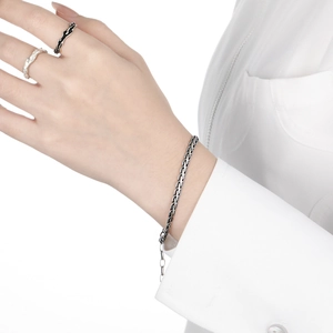 Retro S925 sterling silver snake chain bracelet and textured rings on a female model