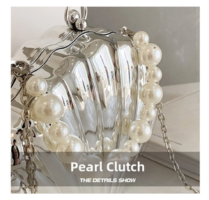 Macro shot of silver mirror metal shell bag with pearl handle and fine chain details