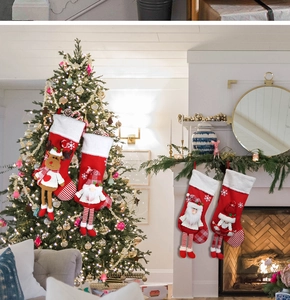 Detailed view of plush long-legged Christmas stockings with 3D reindeer and Santa figures