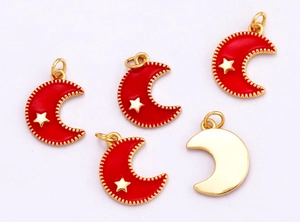 Macro view of red and gold moon star charms showing front and back DIY jewelry details