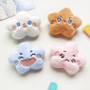 Detail view of plush star accessories in four colors with embroidered facial expressions