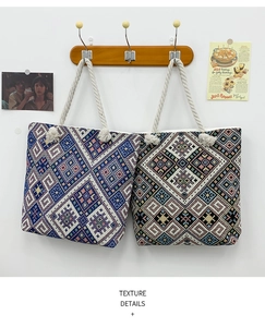 Detail of ethnic embroidery patterns and thick cotton rope handles on two canvas tote bags