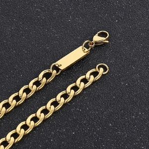 Detailed close-up of 7mm golden Cuban link chain with lobster clasp and blank metal tag