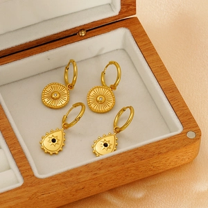 18K gold plated drop earrings set with sun and evil eye charms in a wooden jewelry box