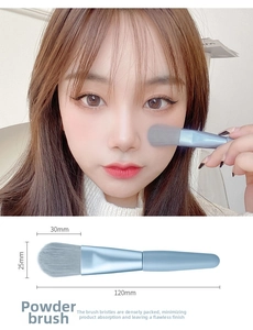 Macro view of 120mm light blue powder brush with soft synthetic bristles for face makeup