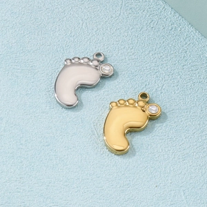 Gold and silver baby footprint pendants with sparkling gemstones on blue background