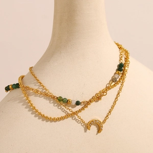 Detailed view of triple-layered 18K gold-plated moon necklace with green beads