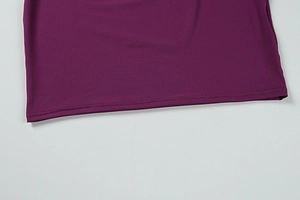 Detail of double-needle stitching on the hem of a purple knitted long-sleeve dress