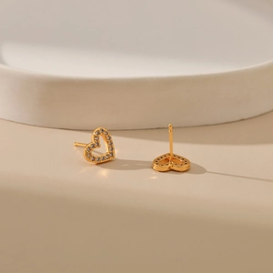Elegant 18K gold heart-shaped stud earrings with micro-pave cubic zirconia on a white stand