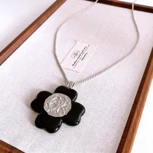 Vintage resin flower pendant necklace with silver rose embossed core on twisted chain