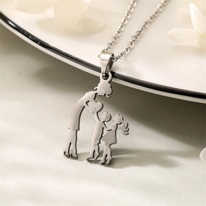 Detailed view of silver mother and two children heart pendant on white plate