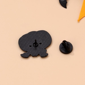Macro view of black enamel brooch back with honeycomb texture and rubber pin clutch