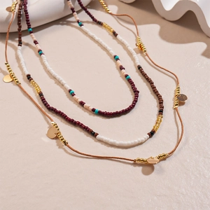 Detail view of 3-piece bohemian beaded waist chain set with glass beads and metal charms