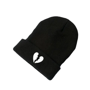 Unisex black knitted beanie with white broken heart embroidery for winter warmth