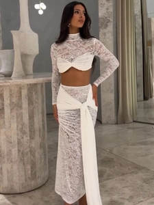 Elegant white two-piece lace set with long sleeve crop top and matching floor-length skirt