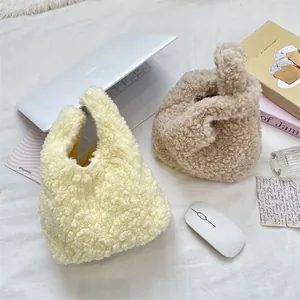 Detail showing plush teddy fleece knot handbags in creamy yellow and light khaki colors