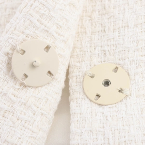 Women's cream white tweed set featuring detailed textured fabric and round buttons