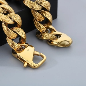 Macro shot of gold-plated punk style chain bracelet with detailed vintage engravings