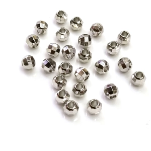 Polished silver faceted metal beads for handmade jewelry making on white background