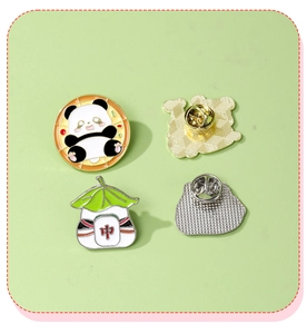Detailed macro view of panda enamel pin with ramen and mahjong motif on metal base