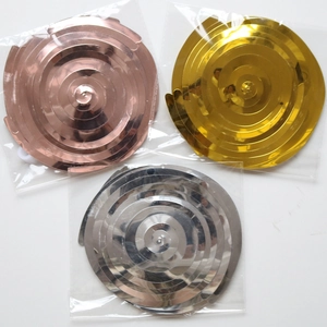 Detail of metallic spiral hanging decorations in rose gold, gold, and silver finishes