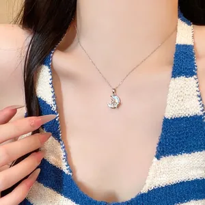 Elegant titanium steel necklace with a moon-cat pendant and round zircon stone on model