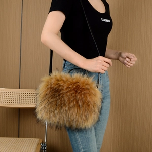 Brown faux raccoon fur shoulder bag detail shown on a model against a wooden backdrop