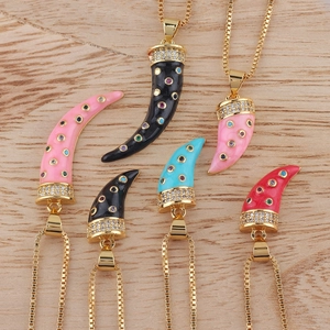 Close-up of horn-shaped necklaces in pink, black, blue and red with crystal inlay detail