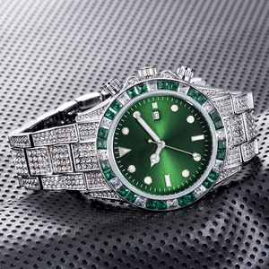 Close-up of diamond-encrusted watch with green sunray dial and green gem bezel