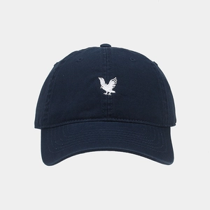 Close-up of precise white eagle embroidery on navy blue cotton twill baseball cap