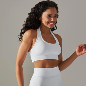 Close-up of white seamless knit yoga set with halter neck top and ribbed waistband