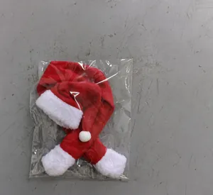 Christmas bottle cover packaging set with mini hat and scarf shown in plastic bag