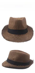 Detail view of brown straw fedora hat featuring frayed edges and black decorative ribbon band