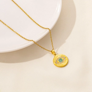 Golden stainless steel necklace featuring evil eye medal pendant with blue zircon stones