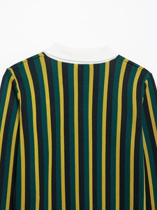 Detail of the green striped knit polo shirt showing white collar and fine texture