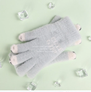 Detail of light blue knit gloves with plush cat paw design and LOVE ME embroidery