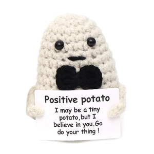 Detail showing hand-knit potato doll holding an encouraging positive potato card