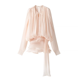 Detail of light pink puff sleeves dress showing pleated texture and drawstring waist
