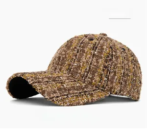 Detail of khaki tweed texture on baseball cap showing thick blended fabric and craftsmanship
