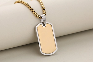 Macro shot of gold and silver military dog tag pendant on a box chain for men