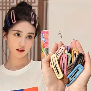 Close-up of matte Morandi colored BB hair clips for styling bangs and loose hair