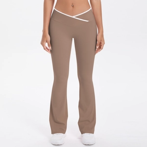 Detail of high-waisted flared yoga pants with mocha brown fabric and white V-cross waistband